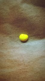 High angle view of yellow leaf on table