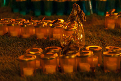 Close-up of glass jar on grass