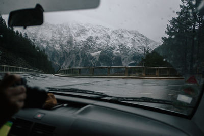 Road seen through car windshield during winter