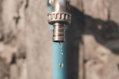 Close-up of faucet against wall
