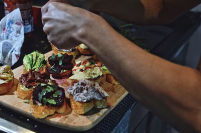 Midsection of man with pizza