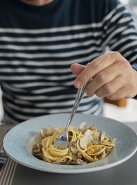 Close-up of hand holding food in plate