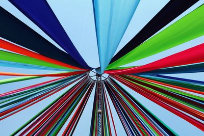 Low angle view of colorful umbrella against clear blue sky