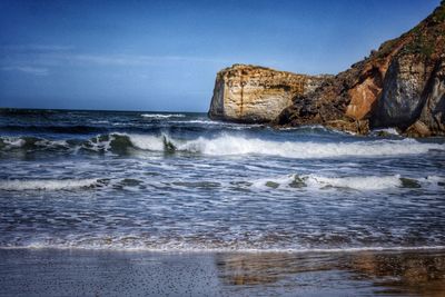 Scenic view of sea against blue sky