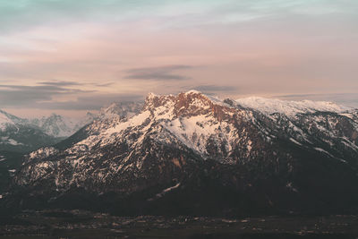 Scenic view of snowcapped mountains against sky during sunset