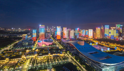 High angle view of illuminated buildings in city at night