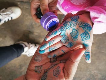 Directly above shot of hands with rubber stamp pattern