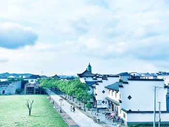 Buildings against cloudy sky