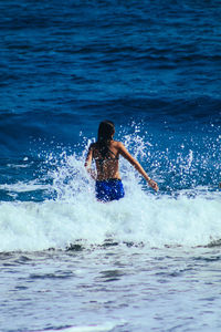 Rear view of woman at beach 