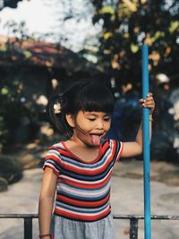 Portrait of cute girl standing in park