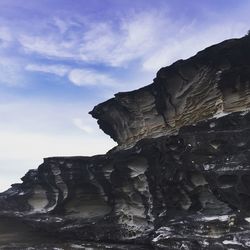 Low angle view of rock formation against sky