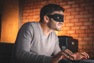 Man wearing sunglasses against wall