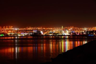 Illuminated city at waterfront