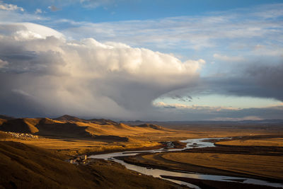 Scenic view of mountains against cloudy sky