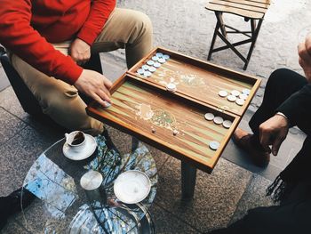 Low section of men playing board game