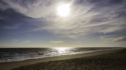 Scenic view of beach against sky during sunset