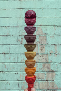 Close-up of ice cream cone against wooden wall many ice cream cone colors