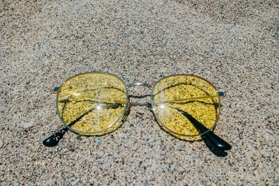High angle view of sunglasses on sand