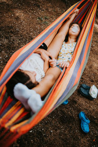 Low section of woman sitting in hammock