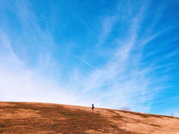 Scenic view of landscape against blue sky