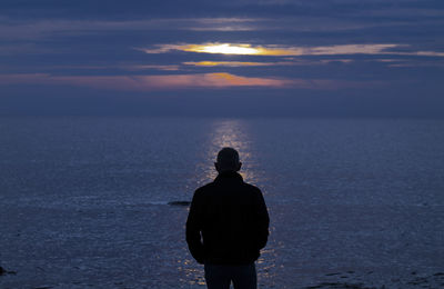 Silhouette of adult man looking at sea during sunset. almeria, spain