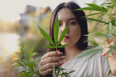 Portrait of young woman amidst plants