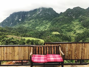 Chairs and trees against mountains