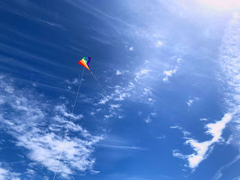 Low angle view of kite flying against blue sky