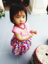 Portrait of cute girl standing at home