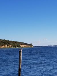 Scenic view of sea against clear blue sky