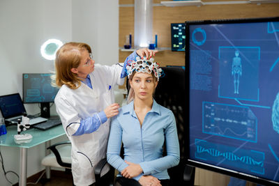 Side view of female doctor working at clinic