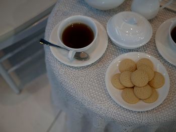 High angle view of coffee and cookies on table