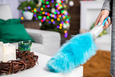 Cropped hand of woman holding christmas tree