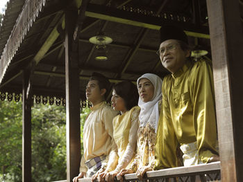 Family standing in gazebo at yard