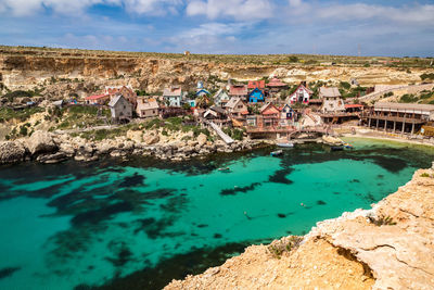 High angle view of swimming pool by sea against sky