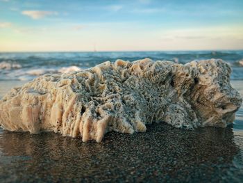 Rocks on beach against sky