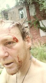 Portrait of young man against building