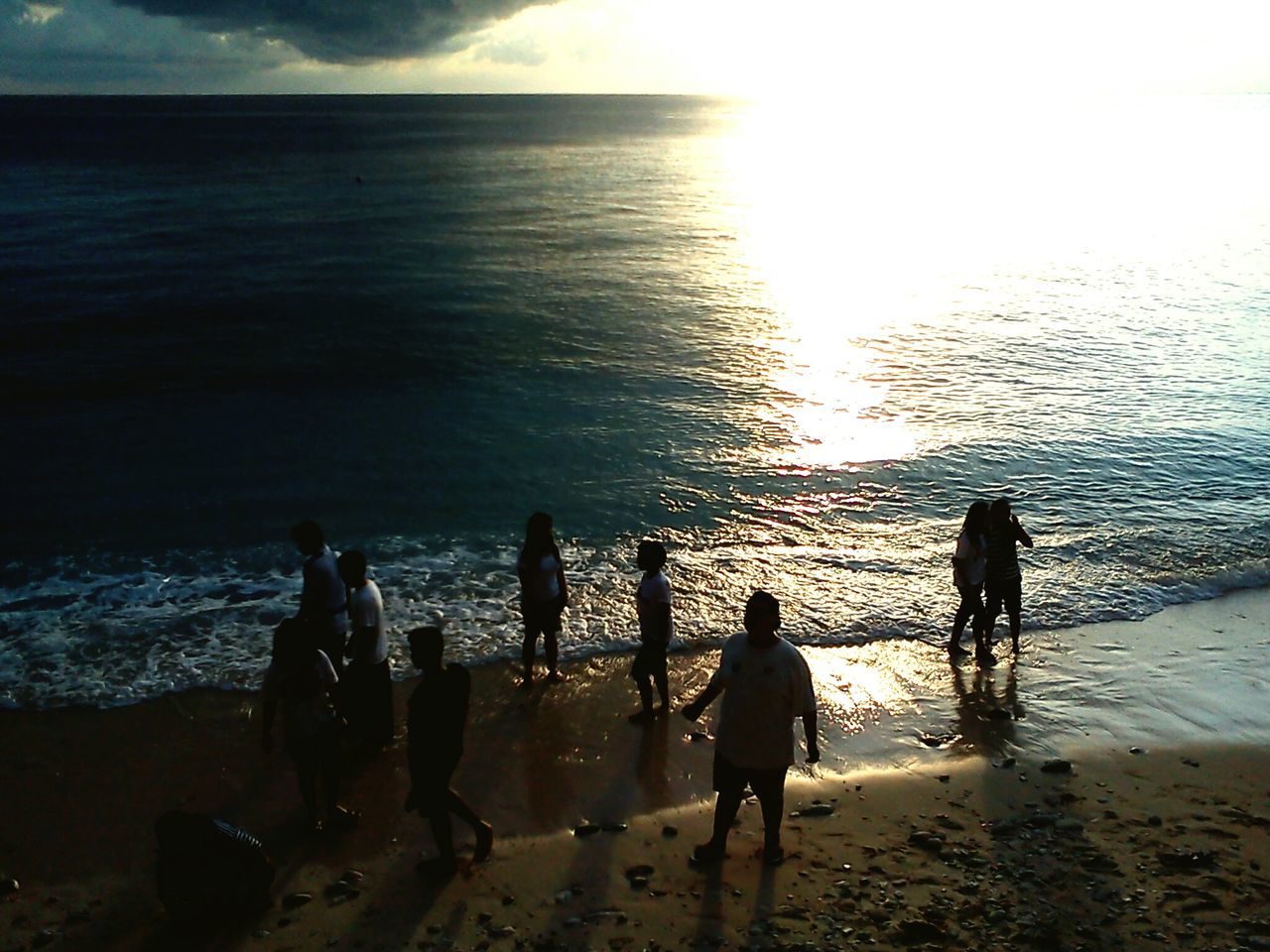 water, sea, beach, shore, horizon over water, silhouette, leisure activity, lifestyles, men, togetherness, vacations, sky, sunset, sand, beauty in nature, scenics, nature, person, medium group of people