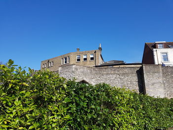 Low angle view of building against clear blue sky