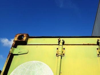 Low angle view of yellow structure against blue sky