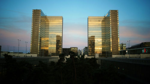 Low angle view of modern buildings against sky in city