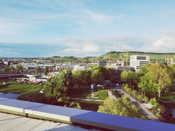 High angle view of buildings and trees against sky