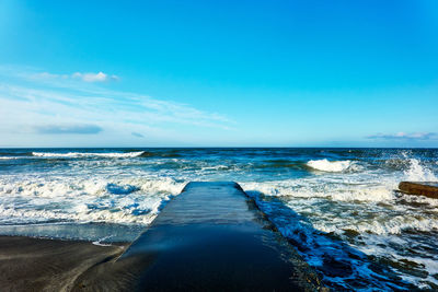 Scenic view of sea against blue sky