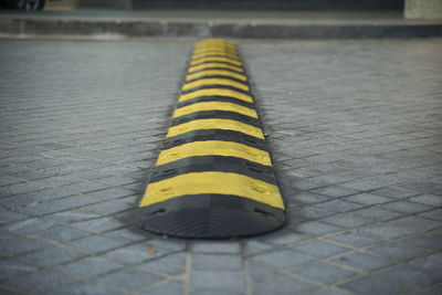 Close-up of yellow umbrella on street