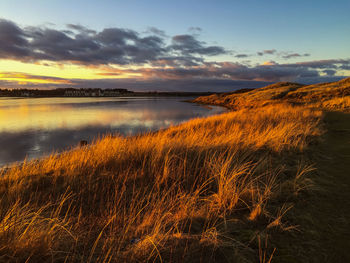 Scenic view of lake at sunset