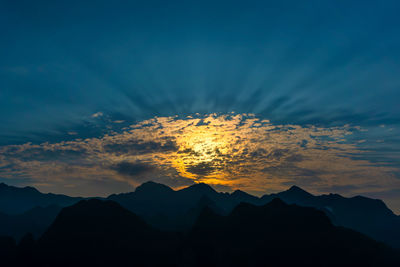 Low angle view of silhouette mountains against sky at sunset