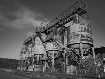 Low angle view of abandoned factory against sky