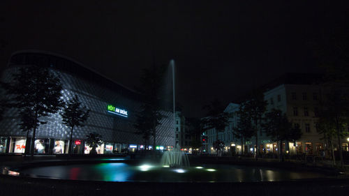 Illuminated city street at night