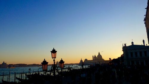 Silhouette of buildings against clear sky during sunset