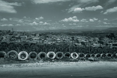 Scenic view of field against sky in city